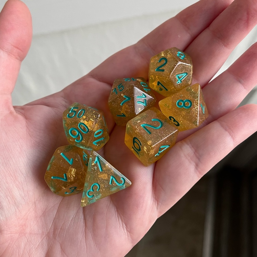 NIB 7-piece TTRPG yellow gold dice set with gold flecks and teal ink